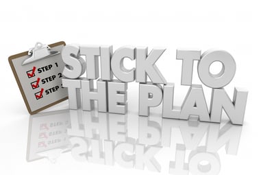 3D text and clipboard that read "Stick to the Plan"