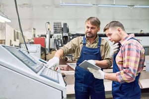 A mentor showing a student something on a computer